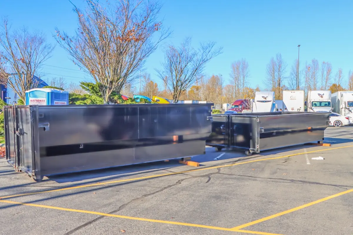 Professional dumpster rental service with roll-off container on residential driveway in Hampstead